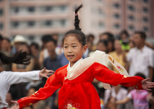 North Korean young girl dancing in traditional choson-ot on national day, DGC, Pyongyang, North Korea
