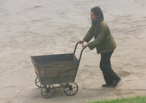 North Korean woman pushing a cart, North Hamgyong, Chongjin, North Korea