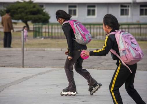 North Korean girls roller skating in town, DGC, Pyongyang, North Korea