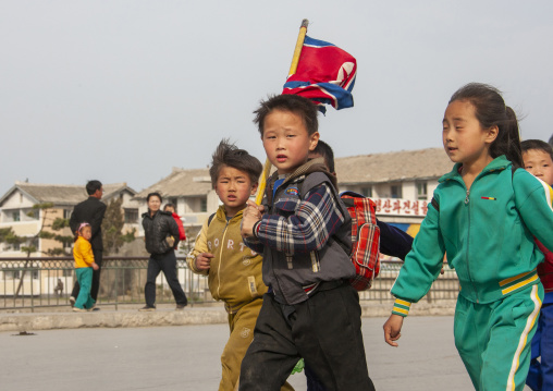 Children parading in the streets on the international workers' day, Kangwon Province, Wonsan, North Korea