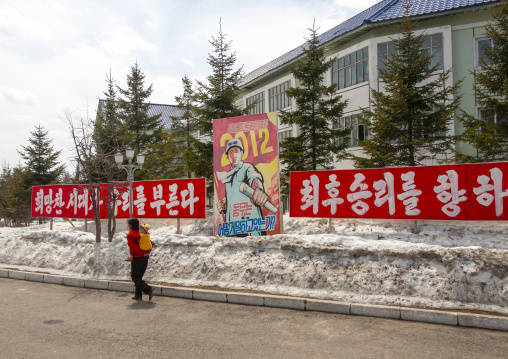 Propaganda billboard with a worker on the road, Ryanggang, Samjiyon, North Korea
