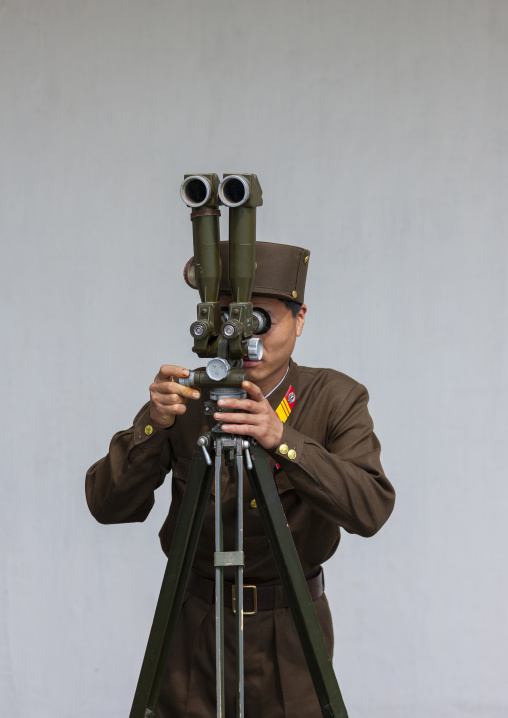 North Korean soldier looking south Korea with binoculars at the DMZ, North Hwanghae, Panmunjom, North Korea