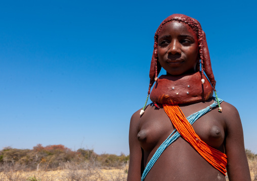 Portrait of a Mumuhuila tribe teenage girl portrait wearing a huge necklace, Huila Province, Chibia, Angola