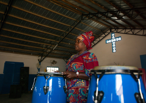 Angolan woman playing drums in a protestant church, Namibe Province, Namibe, Angola