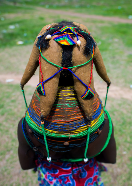 Rear view of a Mumuhuila tribe woman, Huila Province, Chibia, Angola
