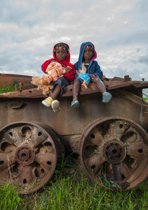 Angolan children playing on a tank wreck, Huambo Province, Huambo, Angola