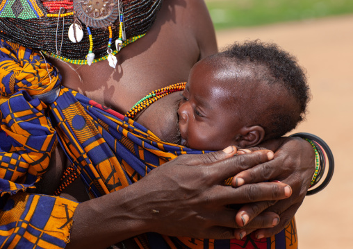 Mumuhuila tribe mother breastfeeding her baby, Huila Province, Chibia, Angola