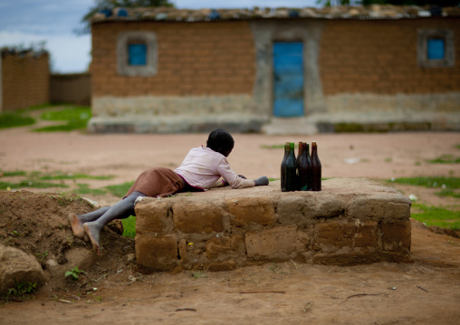 Young Boy Selling Bottles Of Alcohol, Village Of Caconda, Angola
