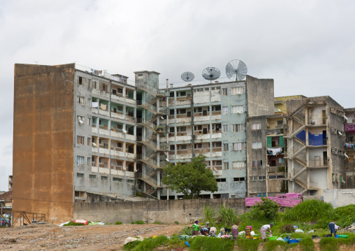 Women Doing The Laundry In Basins In Front Of Their Housing Building, Huambo, Angola