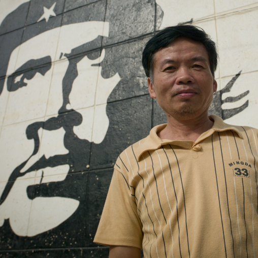 Vietnamese Man In Front Of A Che Guevara Wall Painting, Sumbe, Angola