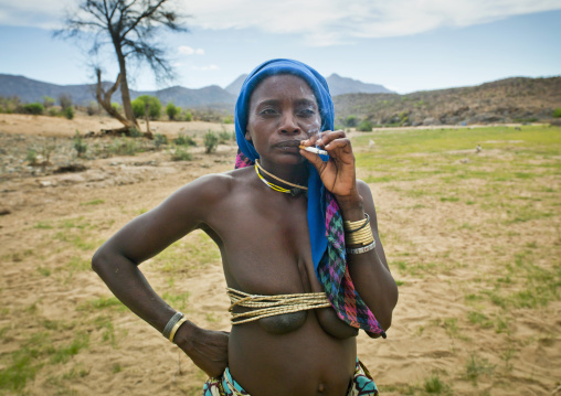 Mucubal Woman With Oyonduthi Bra Smoking A Cigaret, Virie Area, Angola