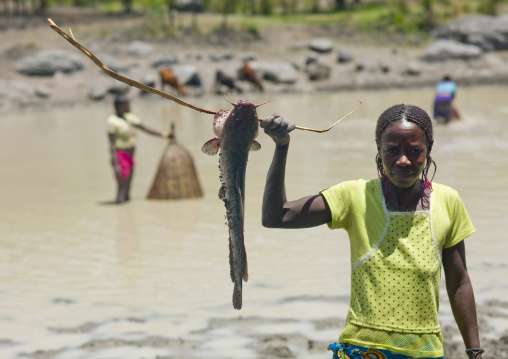Woman Showing The Fish She Caught In The River, Angola