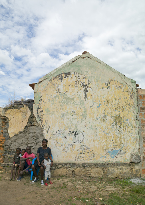 Family Sitting In Front Of Their Dilapidated House, Bilaiambundo, Angola