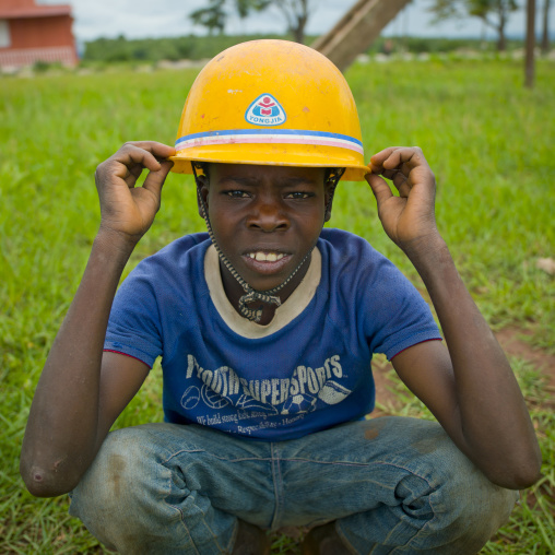 Boy With A Yellow Safety Helmet In Calandula, Angola