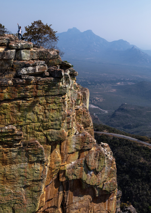 Tourist woman standing on Tundavala gap, Huila Province, Humpata, Angola