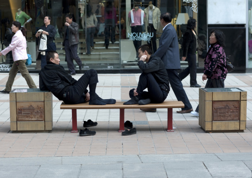 Tired Chinese Men Sit On A Bench, Beijing, China