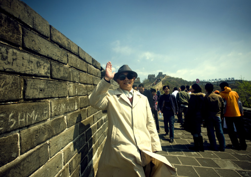 Chinese Old Man Saluting On The Great Wall, Beijing, China