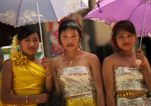 Young Women In Traditional Clothes Holding Umbrellas, Menglun, Yunnan Province, China