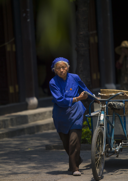 Old Woman With A Bicycle In A Street, Dali, Yunnan Province, China