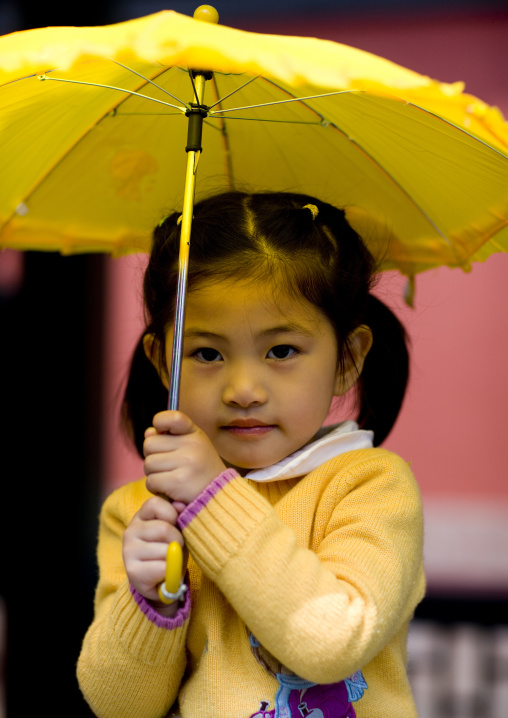 Chinese Girl With A Yellow Umbrella, Beijing, China