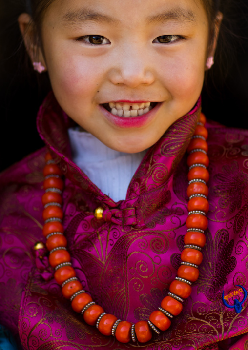 Tibetan child girl with a huge necklace, Tongren County, Rebkong, China