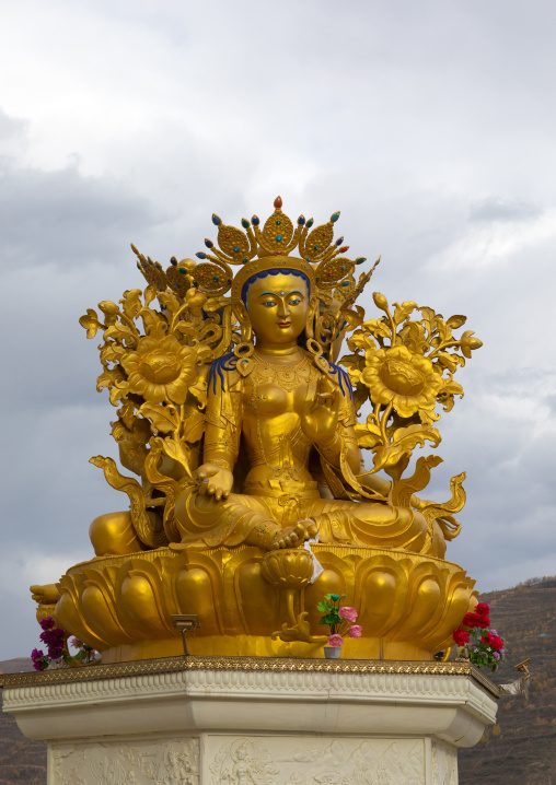 Statue of the buddhist goddess Tara outside longwu monastery, Tongren County, Longwu, China
