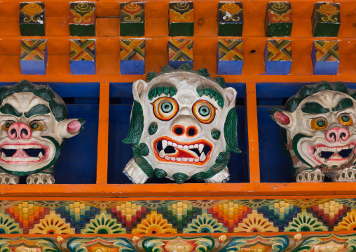 Monsters statues above the entrance of the temple in Bongya monastery, Qinghai province, Mosele, China