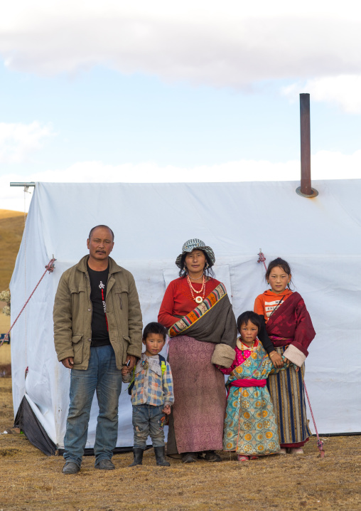 Portrait of a tibetan nomad family living in a tent in the grasslands, Qinghai province, Tsekhog, China