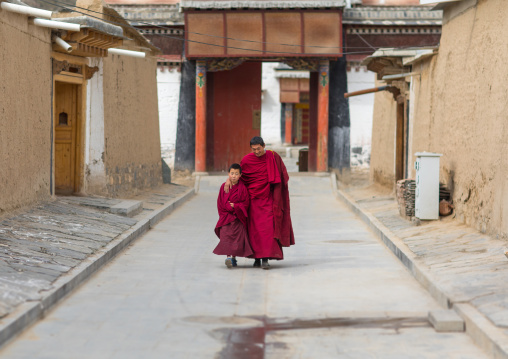 Tibetan monks coming out of a temple in Labrang monastery, Gansu province, Labrang, China
