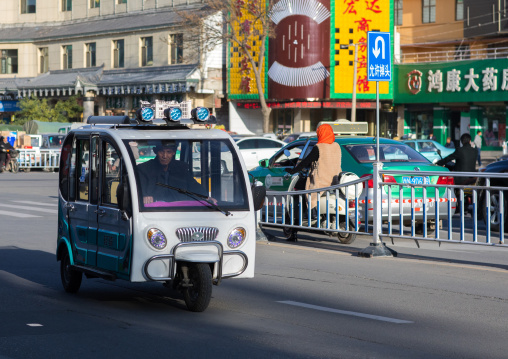 Small taxi in downtown, Gansu province, Linxia, China