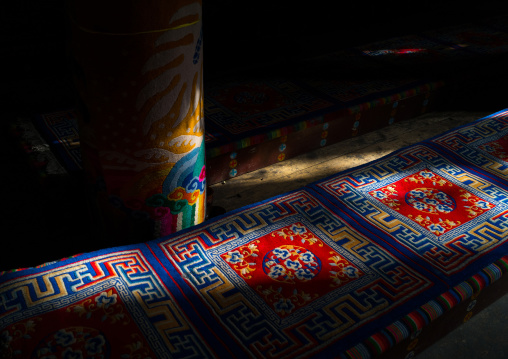 Ray of light on the seats and carpets in Rongwo monastery, Tongren County, Longwu, China