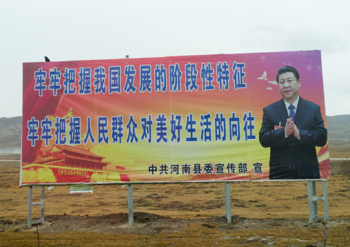 Chinese president Xi Jinping propaganda billboard about development and a good life for the people, Qinghai province, Sogzong, China