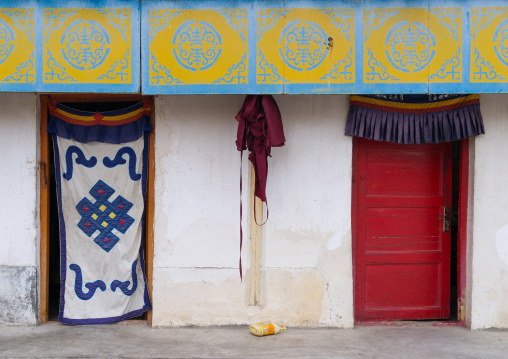 Ornate tibetan doorways of monks houses in Hezuo monastery, Gansu province, Hezuo, China