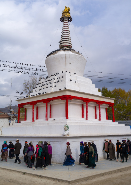 Circumabulation of a stupa by visitors in Labrang monastery, Gansu province, Labrang, China