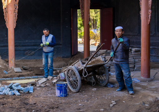 Dong Gong Guan house being renovated by chinese workers, Gansu province, Linxia, China