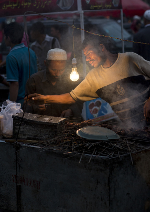 Uyghur Men Preparing Skewers In The Night Market, Hotan, Xinjiang Uyghur Autonomous Region, China