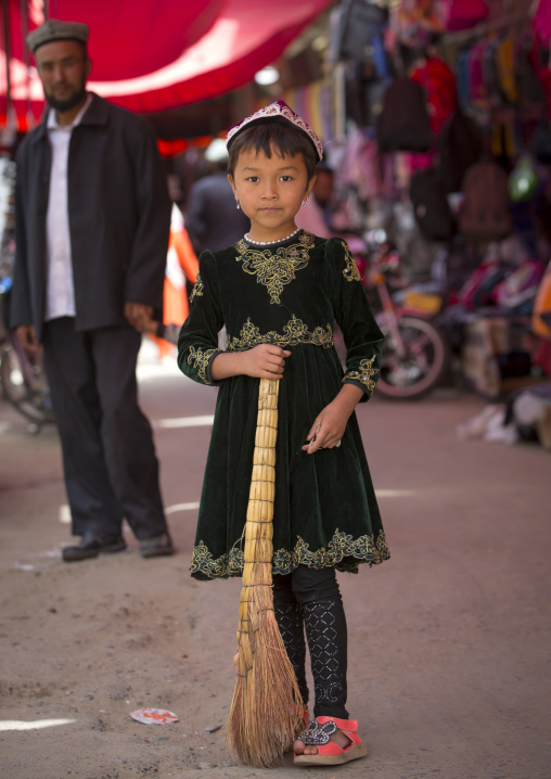 Young Uyghur Girl With A Broom In Minfeng Covered Market, Xinjiang Uyghur Autonomous Region, China