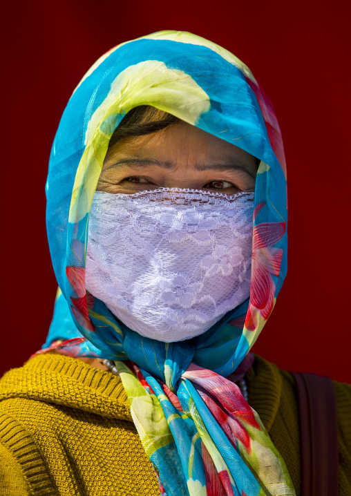 Uyghur Woman With Covered Face And Colourful Headscarf, Xinjiang Uyghur Autonomous Region, China