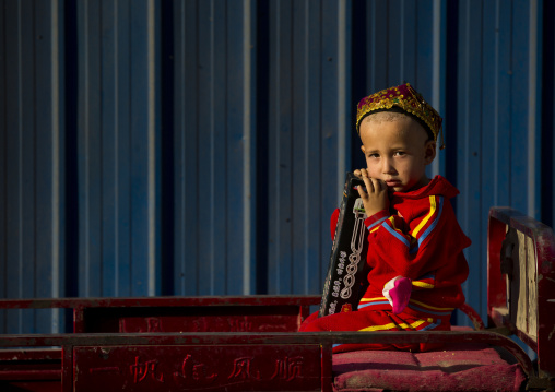 Uyghur Boy Waiting In A Cart, Yarkand, Xinjiang Uyghur Autonomous Region, China
