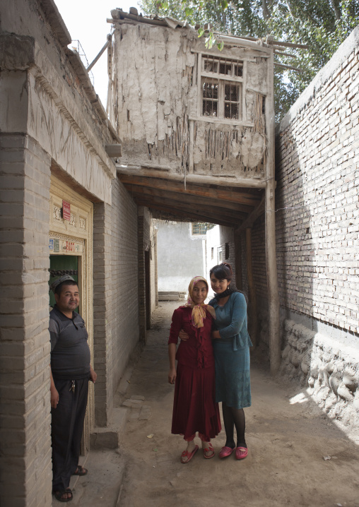 Uyghur Family In A Street Of Minfeng, Xinjiang Uyghur Autonomous Region, China