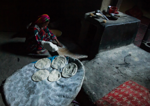Afghan woman making bread inside her traditional pamiri house, Badakhshan province, Khandood, Afghanistan