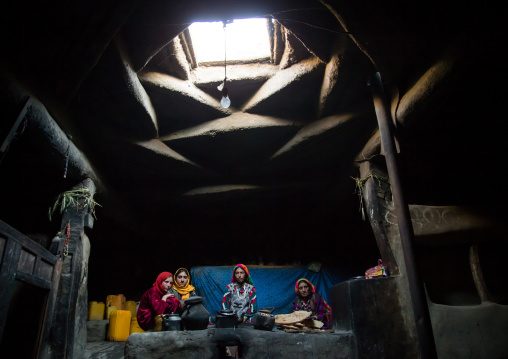 Afghan family inside their traditional pamiri house, Badakhshan province, Khandood, Afghanistan