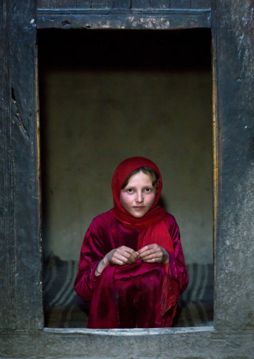 Portrait of an afghan girl with pale skin wearing red clothes, Badakhshan province, Khandood, Afghanistan