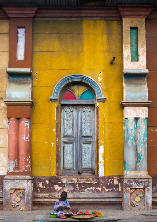 Benin, West Africa, Porto-Novo, child selling tomatoes in front of the multicoloured great mosque
