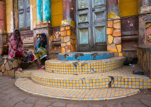 Benin, West Africa, Porto-Novo, teenagers sit on the stairs of the central mosque
