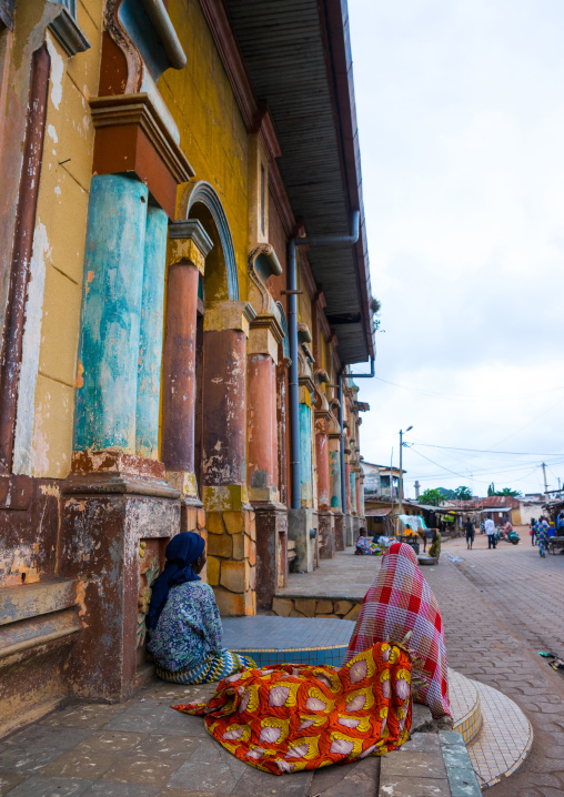 Benin, West Africa, Porto-Novo, teenagers sit in front of the multicoloured great mosque