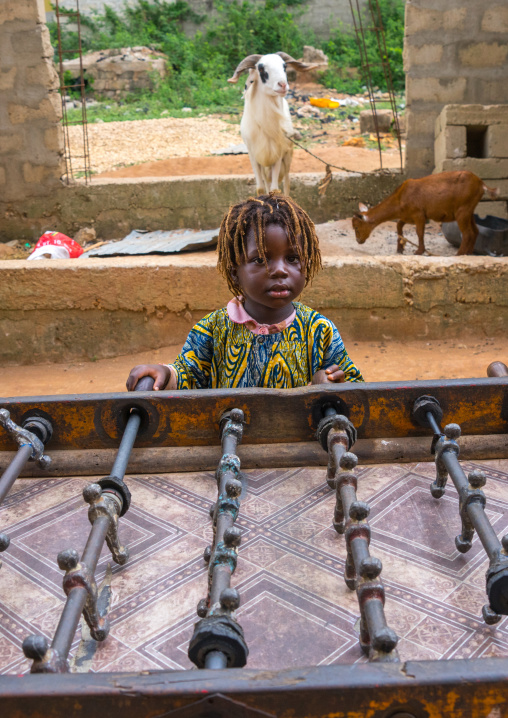 Benin, West Africa, Porto-Novo, girl plays table football babyfoot in the street