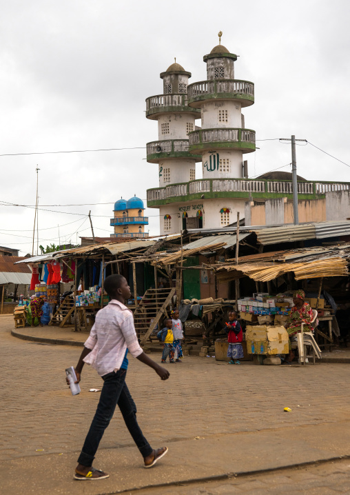 Benin, West Africa, Porto-Novo, man passing in front of aararomi mosque in the street