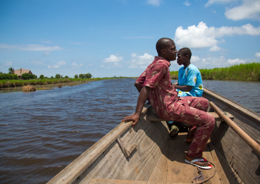 Benin, West Africa, Ganvié, men on a boat on lake nokoue