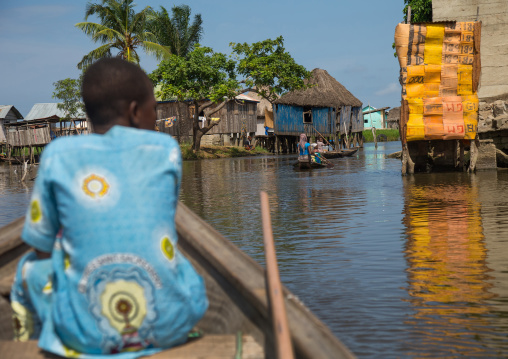 Benin, West Africa, Ganvié, boat passing in front of the stilt village on lake nokoue